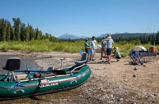 A fishing group having lunch on the beach beside the Flathead River